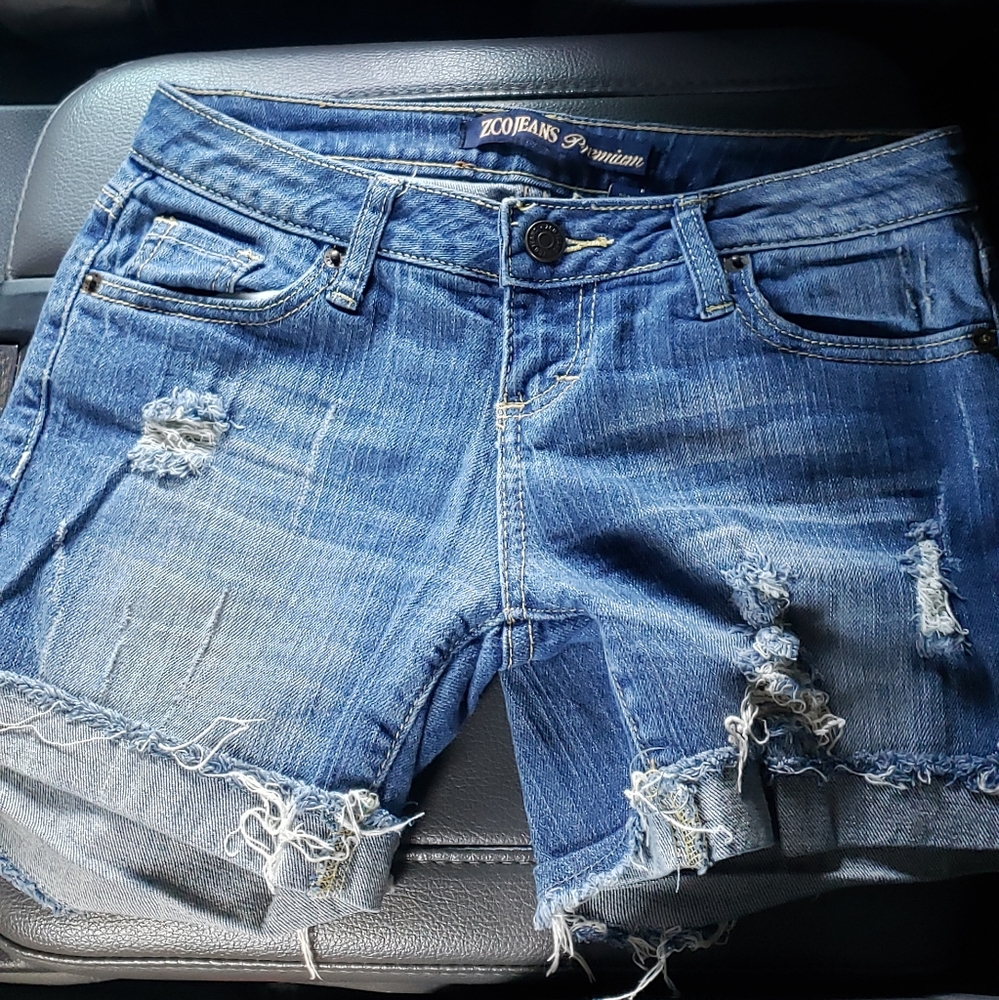 Distressed denim cutoff shorts.